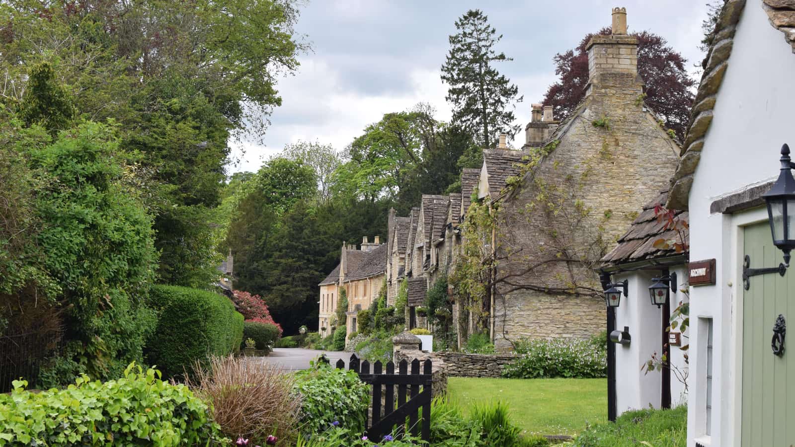 Honey-coloured stone cottages lining the street in Castle Combe