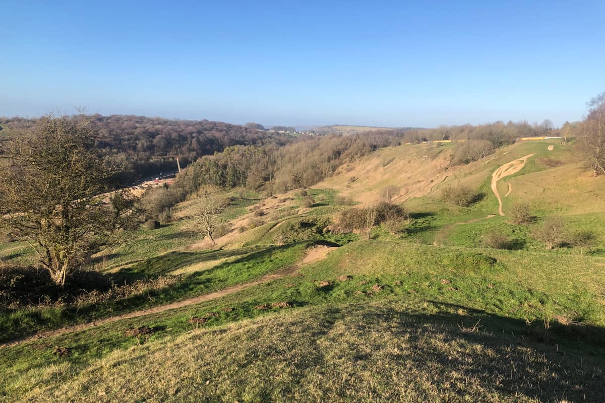 The Cotswold escarpment falling away to the vale, under a clear sky
